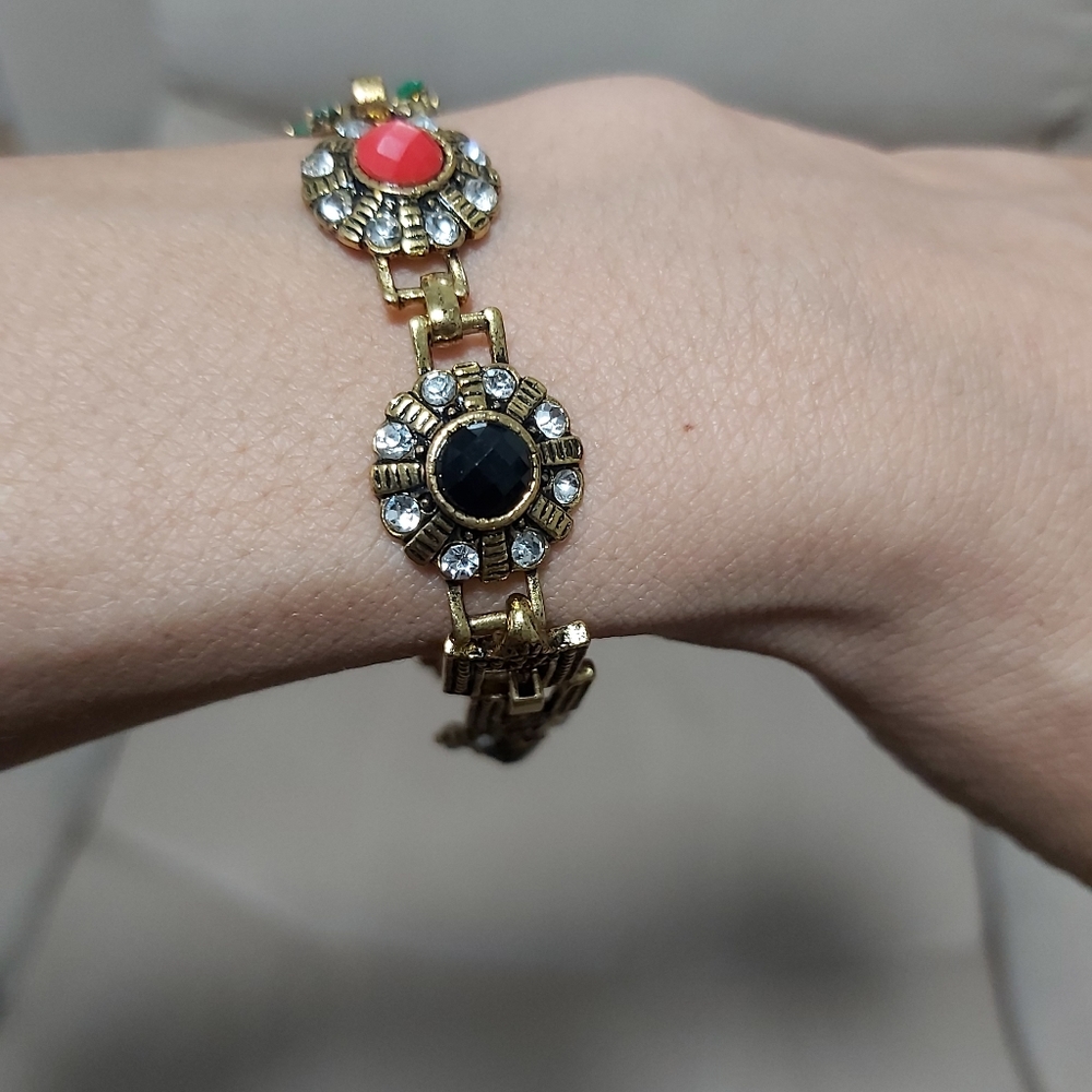925 stamped multi color with rhinestones and gems stone. Gold tone 7" lo…